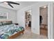 Comfortable bedroom with a ceiling fan, views of the bathroom and walk-in closet at 5250 Callaway St, Port Charlotte, FL 33981