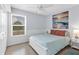 Serene bedroom with soft blue walls, natural light, and a comfortable queen-sized bed at 5250 Callaway St, Port Charlotte, FL 33981