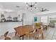 Open concept dining/living area showcases modern lighting, tile floors, and easy access to the kitchen at 5250 Callaway St, Port Charlotte, FL 33981