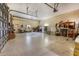View of the large garage interior has several garage doors, storage, and is well-lit from overhead lighting at 5250 Callaway St, Port Charlotte, FL 33981