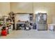 Inside the garage there is a refrigerator, stove, shelving, and some appliances set against the block wall at 5250 Callaway St, Port Charlotte, FL 33981