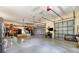 A brightly lit garage interior showing multiple doors, appliances, workbench, and shelving units along the walls at 5250 Callaway St, Port Charlotte, FL 33981