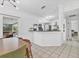 Bright kitchen area with a view to outdoor living space, black countertops and dining area at 5250 Callaway St, Port Charlotte, FL 33981
