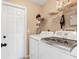 Functional laundry room featuring a modern washer and dryer with convenient storage shelves at 5250 Callaway St, Port Charlotte, FL 33981