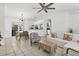 Open living and dining area with a ceiling fan, comfortable sofa, stylish furniture, and view to kitchen at 5250 Callaway St, Port Charlotte, FL 33981