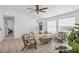 Cozy living room featuring neutral decor, a comfortable sofa, stylish furniture, with an entry door at 5250 Callaway St, Port Charlotte, FL 33981