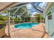 Beautiful kidney-shaped pool, screened-in with a brick paved deck, creating a private oasis at 5250 Callaway St, Port Charlotte, FL 33981