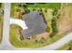 Aerial view of a home with a large driveway, and lush, tropical landscaping at 585 Coral Creek Dr, Placida, FL 33946