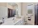 Bright bathroom features a large mirror, and accessible toilet and shower at 585 Coral Creek Dr, Placida, FL 33946