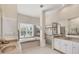 Bright primary bathroom featuring a large soaking tub, double vanity, and walk-in shower at 585 Coral Creek Dr, Placida, FL 33946