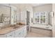 Well-lit bathroom with a soaking tub, double vanity, walk-in shower and access to toilet at 585 Coral Creek Dr, Placida, FL 33946