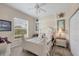 Comfortable bedroom with natural light, ceiling fan, and coastal decor at 585 Coral Creek Dr, Placida, FL 33946