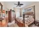 Cozy bedroom with four-poster bed, ceiling fan, and tropical decor accents at 585 Coral Creek Dr, Placida, FL 33946