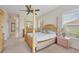Comfortable bedroom with a ceiling fan, and windows overlooking the property at 585 Coral Creek Dr, Placida, FL 33946