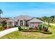 Well-manicured landscaping of this single story home with manicured lawn at 585 Coral Creek Dr, Placida, FL 33946
