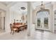 Inviting foyer with tiled floor, chandelier, high ceiling and an adjacent dining area at 585 Coral Creek Dr, Placida, FL 33946