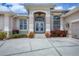 Stately home featuring an arched doorway with glass doors and side panel windows at 585 Coral Creek Dr, Placida, FL 33946