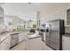 Gourmet kitchen with stainless steel appliances, a center island and views of the lanai at 585 Coral Creek Dr, Placida, FL 33946