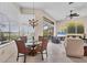 Bright open living space with large windows and a chandelier over glass table at 585 Coral Creek Dr, Placida, FL 33946