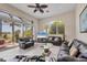 Open-concept living area featuring large windows, comfortable seating, and view to outdoor patio at 585 Coral Creek Dr, Placida, FL 33946