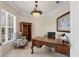 Office with hardwood desk, built-in bookcase, and bright light from the large window at 585 Coral Creek Dr, Placida, FL 33946