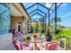Spacious screened patio with comfortable seating and serene view of lush landscaping at 585 Coral Creek Dr, Placida, FL 33946