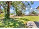 Spacious backyard features mature shade trees and lush green lawn at 5879 Venisota Rd, Venice, FL 34293