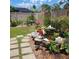 A backyard pond provides an oasis with its rock features, floral accents and angel statues at 5879 Venisota Rd, Venice, FL 34293