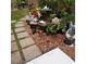 Backyard pond showcasing floral accents, angel statues, and stone pavers in a landscaped setting at 5879 Venisota Rd, Venice, FL 34293