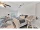 The bright and open bedroom features a neutral color palette and is complemented by white wicker furniture at 5879 Venisota Rd, Venice, FL 34293