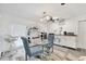The bright eat-in kitchen features white cabinets, stainless appliances, and a modern ceiling fan at 5879 Venisota Rd, Venice, FL 34293