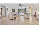 Comfortable living room featuring tile flooring, neutral decor, and a large window offering ample natural light at 5879 Venisota Rd, Venice, FL 34293
