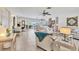 Bright and spacious living room with tile floors, ceiling fans, and sliding doors leading to an outdoor area at 5879 Venisota Rd, Venice, FL 34293