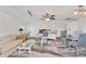 Bright interior features a neutral palette with a sofa and decorative white wicker furniture at 5879 Venisota Rd, Venice, FL 34293