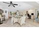 Open-concept living space with tile floors, a desk, and a view of the backyard through a window at 5879 Venisota Rd, Venice, FL 34293