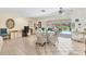 Bright living area with tile floors, a desk, and a view of the outdoor pool area through sliding glass doors at 5879 Venisota Rd, Venice, FL 34293