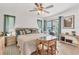 Serene main bedroom featuring tile floors, a ceiling fan, and sliding glass doors leading to the outdoors at 5879 Venisota Rd, Venice, FL 34293