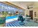 Inviting screened-in patio offers outdoor dining and lounging spaces with a view of the refreshing swimming pool at 5879 Venisota Rd, Venice, FL 34293