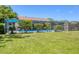 Relax by the screened-in pool featuring lush landscaping, perfect for enjoying outdoor living at 5879 Venisota Rd, Venice, FL 34293
