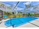 Sparkling screened-in swimming pool offers a refreshing escape in a private backyard setting at 5879 Venisota Rd, Venice, FL 34293