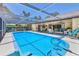 Spacious screened-in pool with comfortable seating area, ideal for outdoor entertaining and leisure at 5879 Venisota Rd, Venice, FL 34293