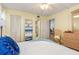Bright bedroom with yellow walls, white closet, and view to the bathroom and dining areas at 708 Tamiami S Trl # 216, Venice, FL 34285