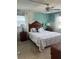 Bright bedroom with a comfortable queen-sized bed, ceiling fan, and two large windows at 708 Tamiami S Trl # 216, Venice, FL 34285