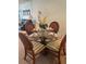 The dining area features a glass table with seating for four and decorative place settings at 708 Tamiami S Trl # 216, Venice, FL 34285
