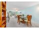 Cozy dining room featuring a round glass table with seating for four, carpeted floors, and bright paint at 708 Tamiami S Trl # 216, Venice, FL 34285