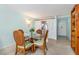 Cozy dining area features a round glass table with seating for four and bright walls at 708 Tamiami S Trl # 216, Venice, FL 34285