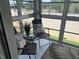 Enclosed lanai, furnished with outdoor seating, creating a relaxing space with nature views at 708 Tamiami S Trl # 216, Venice, FL 34285