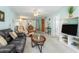 Inviting living room with a view into the dining area, a large sofa, and neutral-colored carpet at 708 Tamiami S Trl # 216, Venice, FL 34285