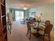 Inviting living room with lots of light, a ceiling fan and an adjacent dining area at 708 Tamiami S Trl # 216, Venice, FL 34285