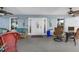 Cozy covered patio with tropical-themed furniture, perfect for relaxation and entertaining at 708 Tamiami S Trl # 216, Venice, FL 34285